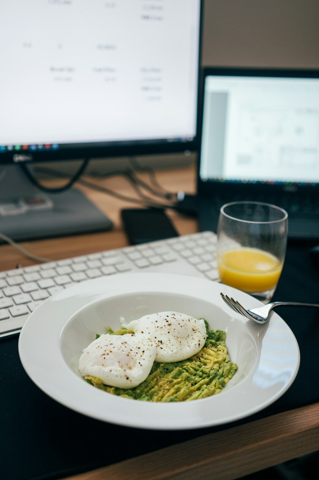 Flat lay of a notebook, laptop and healthy food on a desk
