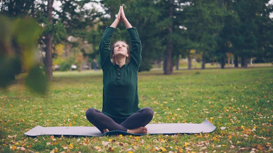 person doing yoga outdoors